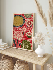 Red folk art print with plate of noodles, sliced grapefruit, pomegranate, and white flowers, in an alternate framed mockup