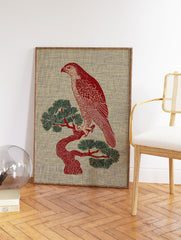 Red hawk illustration perched on a green pine tree, against a textured beige background. Illustrative bird wall art. - Image 2