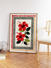 Red hibiscus wall art print with two vibrant flowers, green leaves, and decorative folk art borders on a cream background. - Image 2