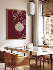 Illustrative off-white Chinese lantern with peonies and berries on a deep red background, in a styled room mockup