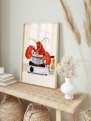 Watercolour illustration of a red lobster cooking spaghetti on a portable gas stove with a, in an alternate framed mockup
