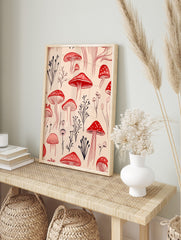 Red mushroom and dark botanical illustration art print on a pale beige background, featuring, in an alternate framed mockup