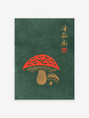 Red mushroom illustration with gold Japanese calligraphy on a dark green background, woodblock print style