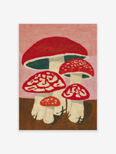 Red and white spotted mushroom wall art print with cream stems, brown ground, and pink background