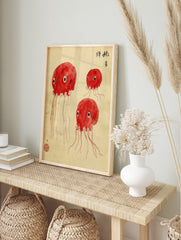 Red, multi-eyed octopus creatures illustration in Japanese ink wash style on off-white, in an alternate framed mockup