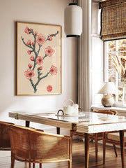 Red and pink plum blossom branch illustration with buds, dark grey stem, and a red circular seal on, in a styled room mockup