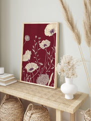 Cream line art poppy flowers and foliage on a deep maroon background in a botanical, in an alternate framed mockup