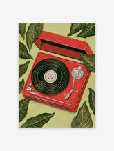 Illustrative print of a red record player surrounded by large green tropical leaves on a light green background
