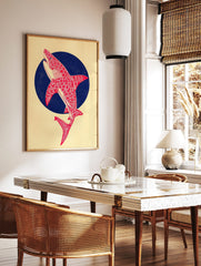 Red patterned shark illustration leaping from a dark blue circle on a cream background, portrait, in a styled room mockup