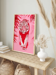 Red and white illustrative tiger walking forward, framed by red tropical leaves on a pink, in an alternate framed mockup