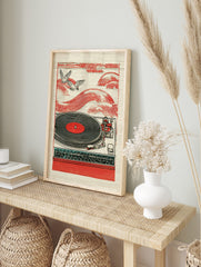 Red turntable with black vinyl record, two flying birds, and red wave patterns in, in an alternate framed mockup
