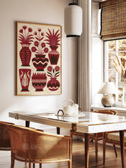 Illustrative red vase wall art with stylized flowers and leafy plants on a textured cream background, in a styled room mockup