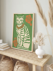 Illustrative retro cat wall art print with green stripes, orange flower lei, and green, in an alternate framed mockup