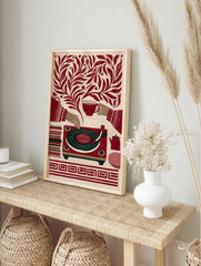 Retro illustrative print of a record player, teacup, and teapot surrounded by botanical, in an alternate framed mockup