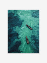 Aerial view of two wooden boats on a river with swirling teal and turquoise water, abstract nature photography.