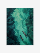 Aerial view of two wooden boats on a winding river with vibrant green, swirling water, surrounded by dense forest. River wall art.