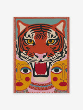 Stylised roaring orange and black tiger head with yellow eyes, and two yellow human-like faces below, on a teal and pink