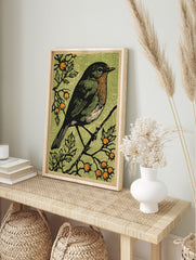 Woodcut style art print of a robin bird with orange breast on a branch with green leaves and, in an alternate framed mockup