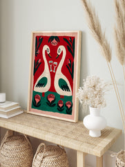 Romantic folk art painting of two cream swans with wine glasses, red background, green, in an alternate framed mockup
