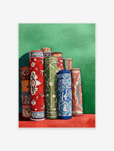 Watercolor rug art print depicting several rolled colorful carpets with intricate cultural patterns against a green wall.