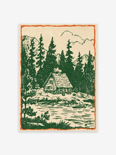 Rustic cabin wall art print showing a vintage illustration of a cabin by a forest lake with pine trees and mountains.