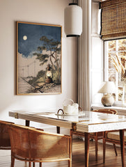 Illustrative rustic lantern glowing by railway tracks under a full moon in a blue night sky with a, in a styled room mockup