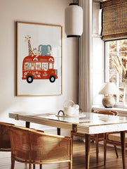 Illustrative wall art of safari animals on a red double-decker bus, featuring a giraffe, elephant, in a styled room mockup