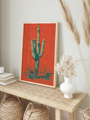 Saguaro cactus art print in orange-red and teal halftone style, with desert foliage at the, in an alternate framed mockup