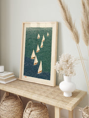 Illustrative woodcut print of nine sailboats with white sails on wavy teal and blue water, in an alternate framed mockup