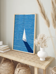 Minimalist sailboat wall art on a blue ocean with white wavy stripes and a long dark shadow, viewed from above. - Image 3