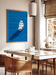 Illustrative sailboat wall art on a blue ocean with horizontal waves and a long shadow, featuring a white boat with brown accents. - Image 2