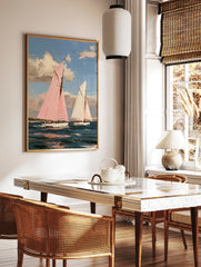 Impressionist painting of two sailboats, one with a pink sail, on a blue sea under a sky with clouds, in a styled room mockup