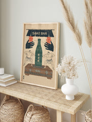 Vintage Japanese sake bar print with two sumo wrestlers, green sake bottle, and "SAKE BAR", in an alternate framed mockup