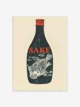 Dark blue sake bottle with red 'SAKE' text and white fish illustration inside, red cap, cream background