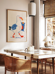 Illustrative seagull art print walking with a blue bag of crisps in its beak on a white background, in a styled room mockup
