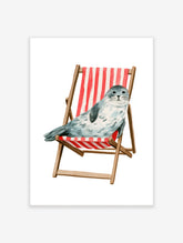 Watercolour illustration of a spotted grey seal sitting in a red and white striped wooden deckchair on a white background