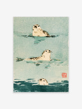 Watercolour seal wall art print with three harbour seals in teal water and a red stamp