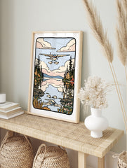 Illustrated seaplane flying over a calm lake with pine forest reflections and soft clouds in, in an alternate framed mockup
