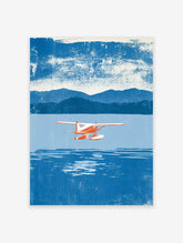 Red and white seaplane flying over blue water with mountains in the background, illustrative style art print