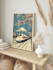 Japanese woodblock print of Shinkansen bullet train, Mount Fuji, and red cherry blossoms, in an alternate framed mockup
