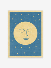 Stylised sleeping moon face illustration with closed eyes and gold stars on a blue background, celestial wall art print