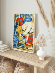 Illustrative art print of a sleeping polar bear on a yellow armchair with blue botanical, in an alternate framed mockup