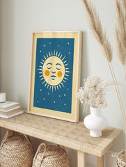 Retro sleeping sun illustration with orange cheeks and stars on a deep blue background, in an alternate framed mockup
