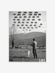 Monochrome print of a man and dog aiming shotgun at pixelated Space Invaders in a rural landscape