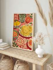 Spaghetti dinner still life art print with pasta, lemons, pumpkin on striped and floral red, in an alternate framed mockup