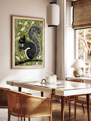 Black squirrel linocut art print on a green background, holding an acorn while sitting on a branch, woodland animal decor. - Image 3