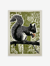Black and white linocut art print of a squirrel holding an acorn on a branch against an olive green forest background.