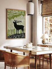 Lino cut style art print of a black stag deer in a green and white forest with hills and wildflowers, in a styled room mockup