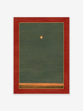 Framed star art print with a glowing star in a dark green sky above an orange horizon, featuring a red mat.