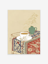 Still life wall art illustration of a tea cup, green vase with plant, and patterned red and blue textile on a table.